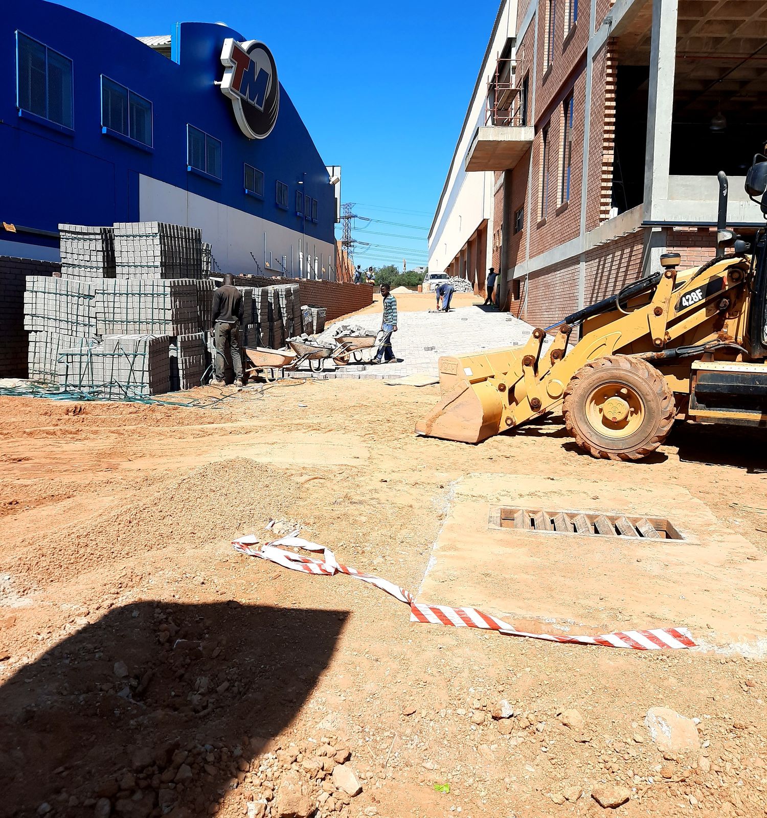 Large-scale commercial paving development in progress with equipment on site