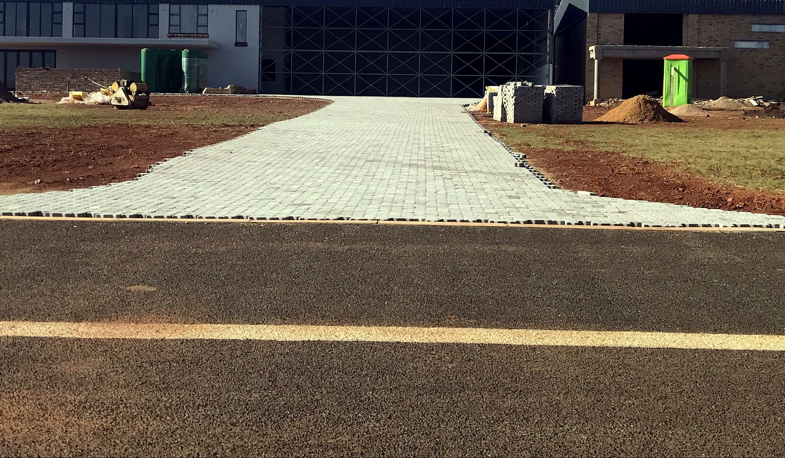 Wide commercial estate access road leading to office buildings