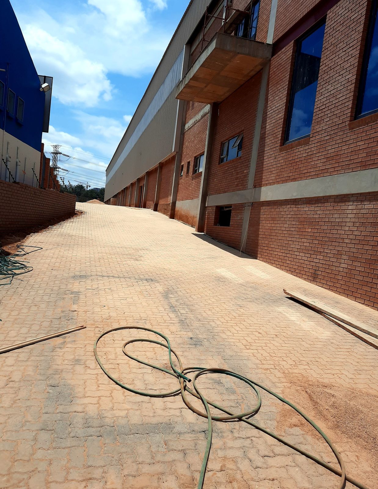 Terracotta herringbone paving along a commercial warehouse walkway